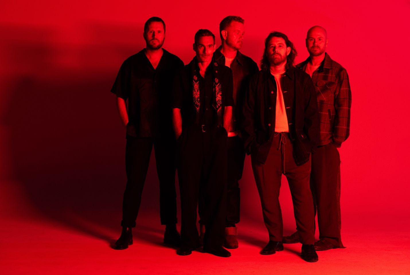 Red hued image of the band Boy & bear